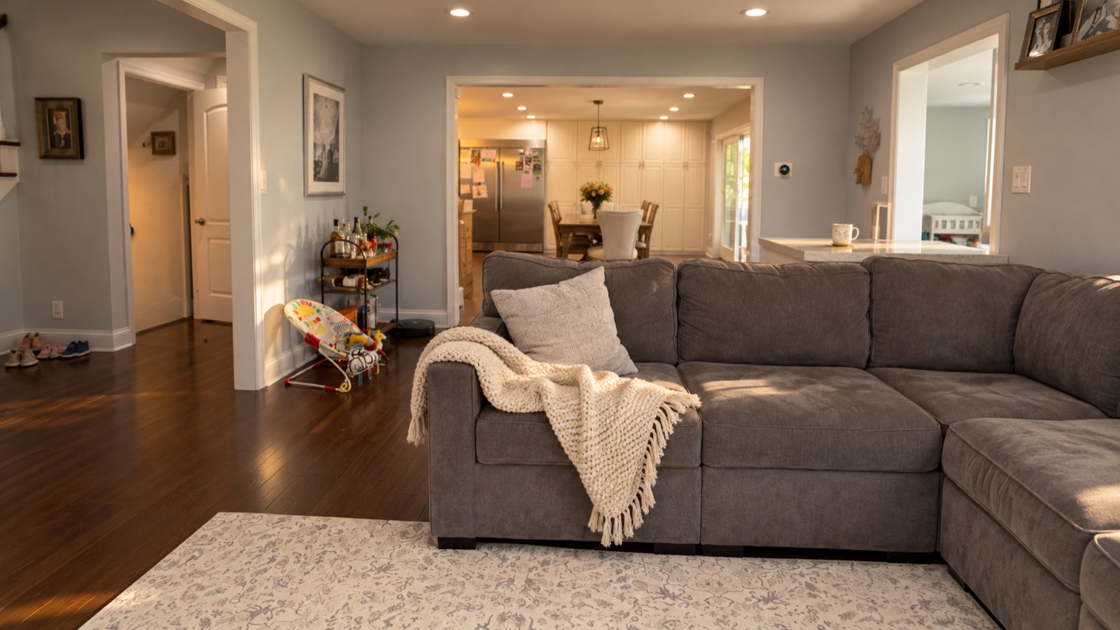 AI storyboard · Details: coffee mug on the counter, kids’ shoes by the door, a blanket on the sectional